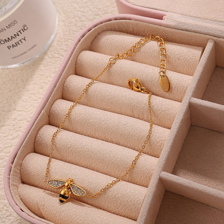 The Jazzy Owl BeeMine Bracelet, a delicate gold-tone chain with a mini bee charm